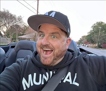 Man with a big smile enjoying a car ride